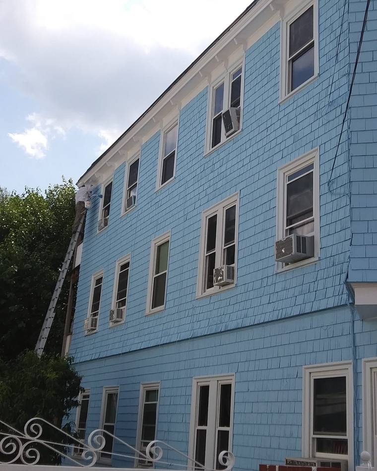 Same home fully repainted in light blue with white trim