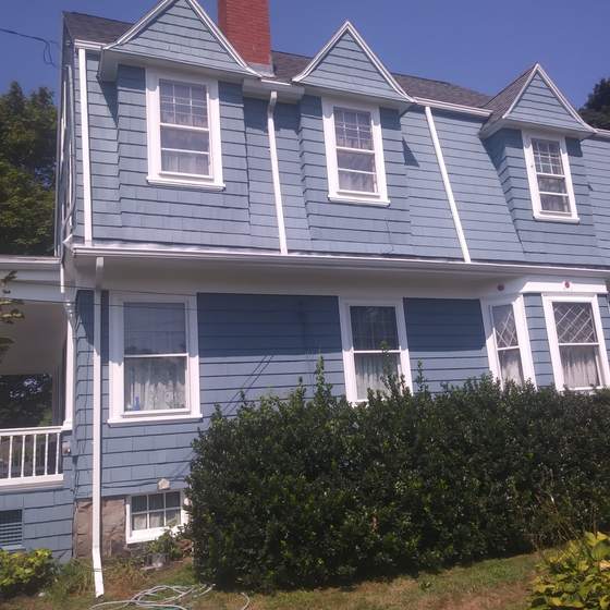 Gambrel home repainted in blue with white trim