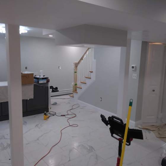 Finished lower level with painted walls and stair rail