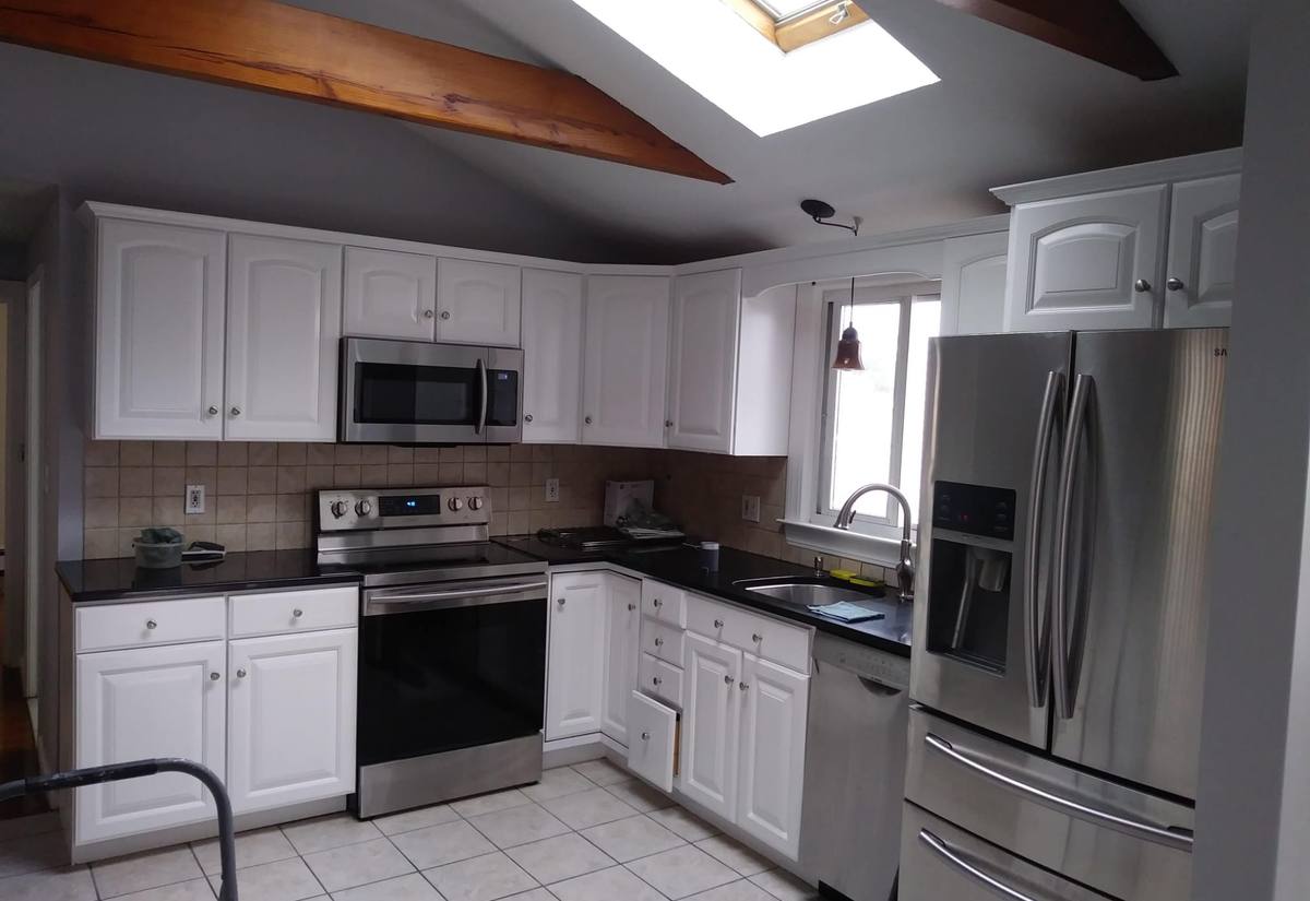 Kitchen interior with freshly painted white cabinets